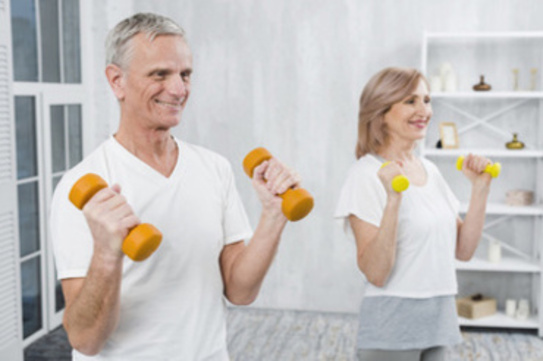 Man and women starting their morning with strength training exercises to stay young and healthy.